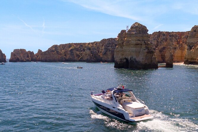 Full day private yacht from lagos with drinks, tapas, paddle boards and kayak - Route choice from Marina de Lagos: Portimão and Benagil caves or Sagres coast