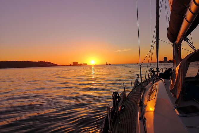 Lisbon Sunset Sailing Tour on Luxury Sailing Yacht with 2 Drinks - Drinks and Portuguese cheese at golden hour