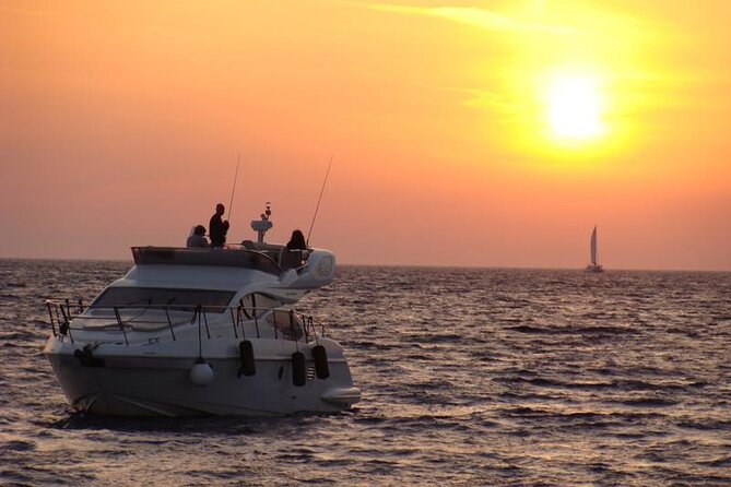 Private Motor Yacht Cruise with BBQ, Open Bar & Transfers - Past caves and rock formations: the part that feels like Santorini from a movie