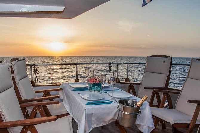 Santorini: Motor Yacht Sunset Cruise with 5-Course Dinner - Dinner on Board: Five Courses, Drinks, and Real-Time Timing