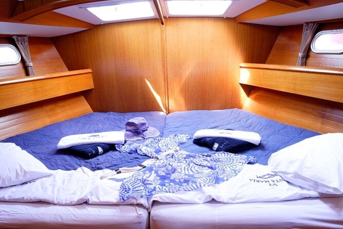 Santorini: Private Sailing Yacht Cruise with Meal and Drinks - Mesa Pigadia: Black Sand, Clear Water, and a Quieter Shore
